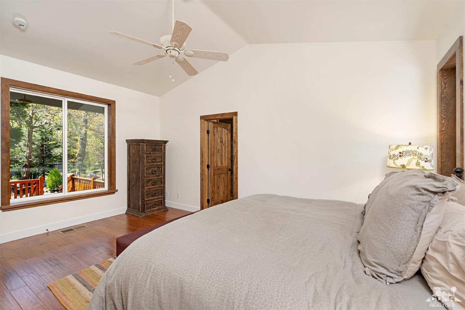 24838 Fern Valley Road Idyllwild, CA 92549 - Photo 15 of 38 a bedroom with a bed and a large window
