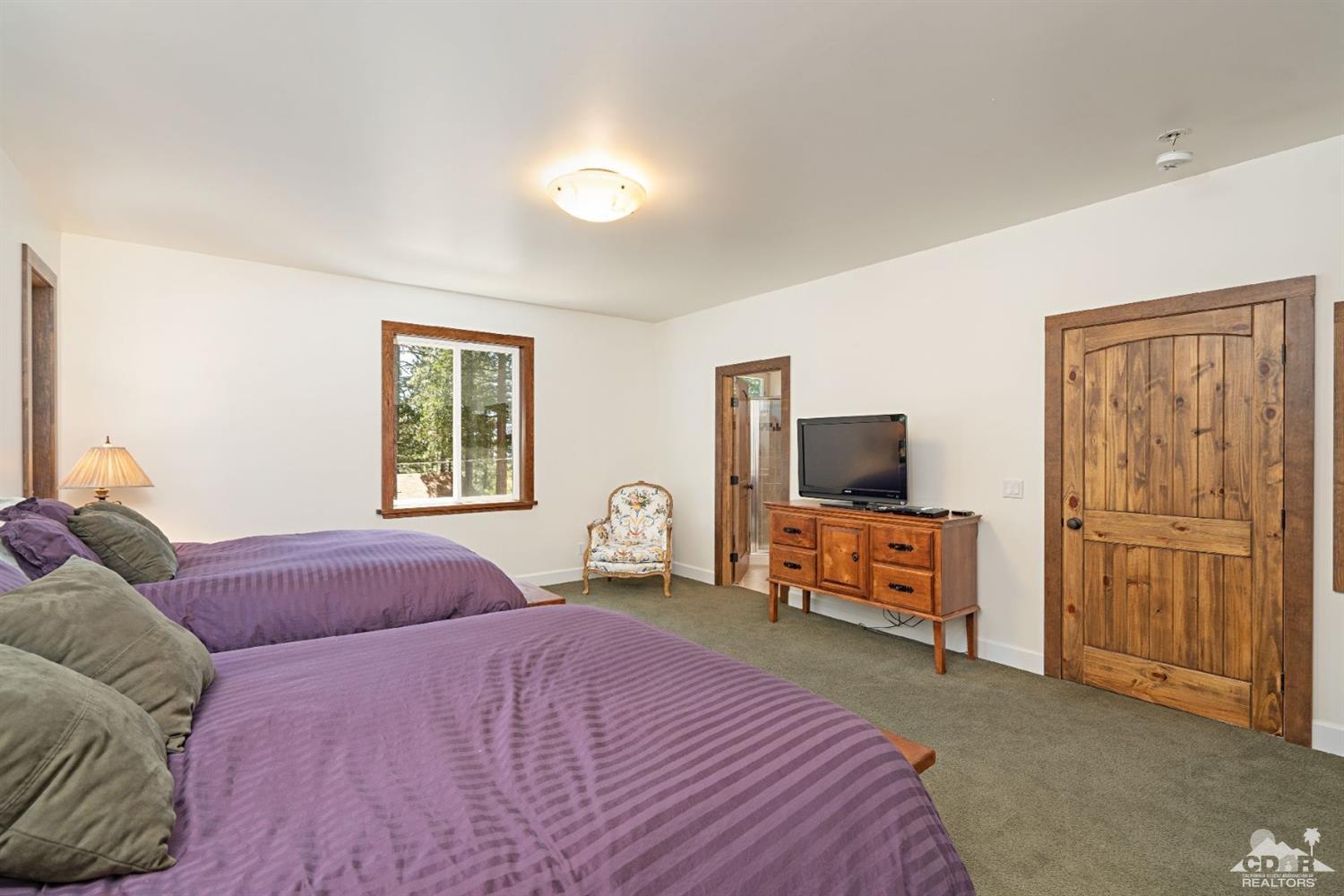 24838 Fern Valley Road Idyllwild, CA 92549 - Photo 18 of 38 a bedroom with a bed and wooden floor