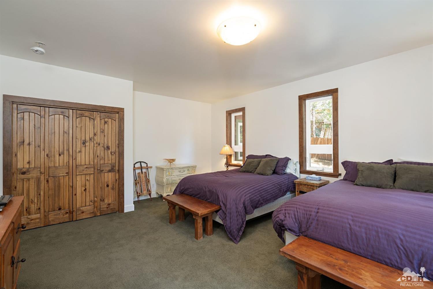 24838 Fern Valley Road Idyllwild, CA 92549 - Photo 20 of 38 a bedroom with two beds and a window