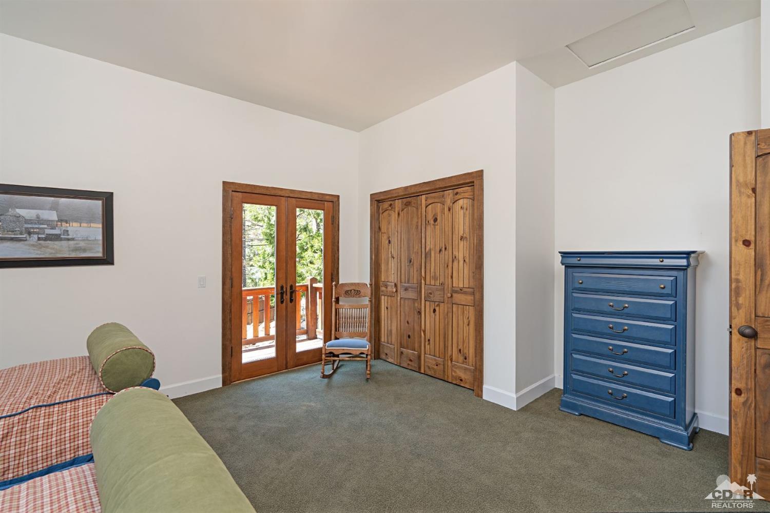 24838 Fern Valley Road Idyllwild, CA 92549 - Photo 22 of 38 a living room with furniture and a window