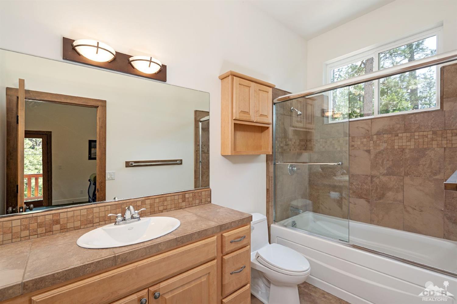 24838 Fern Valley Road Idyllwild, CA 92549 - Photo 24 of 38 a bathroom with a sink a toilet and shower