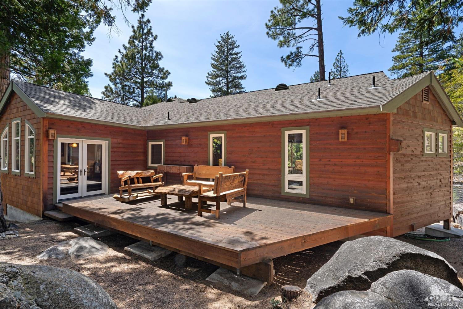 24838 Fern Valley Road Idyllwild, CA 92549 - Photo 4 of 38 a view of a patio with table and chairs with wooden floor and fence