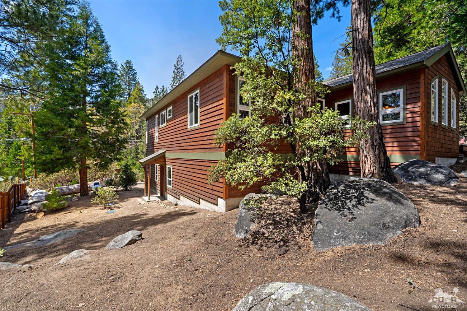 24838 Fern Valley Road Idyllwild, CA 92549 - Photo 31 of 38 a backyard of a house with lots of green space
