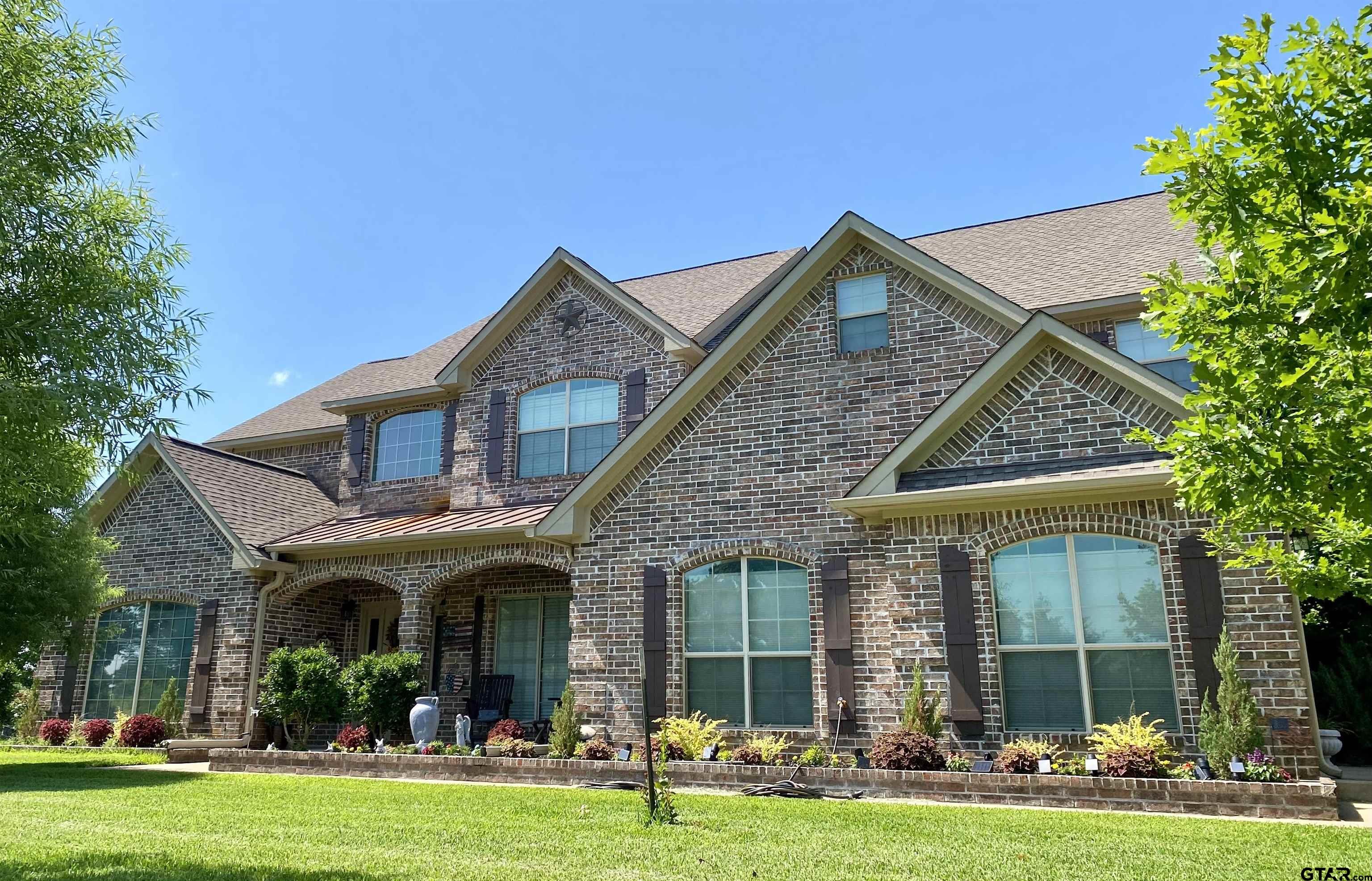 23120 Saddle Ridge Court Lindale, TX 75771 - Photo 1 of 34 a front view of a house with garden