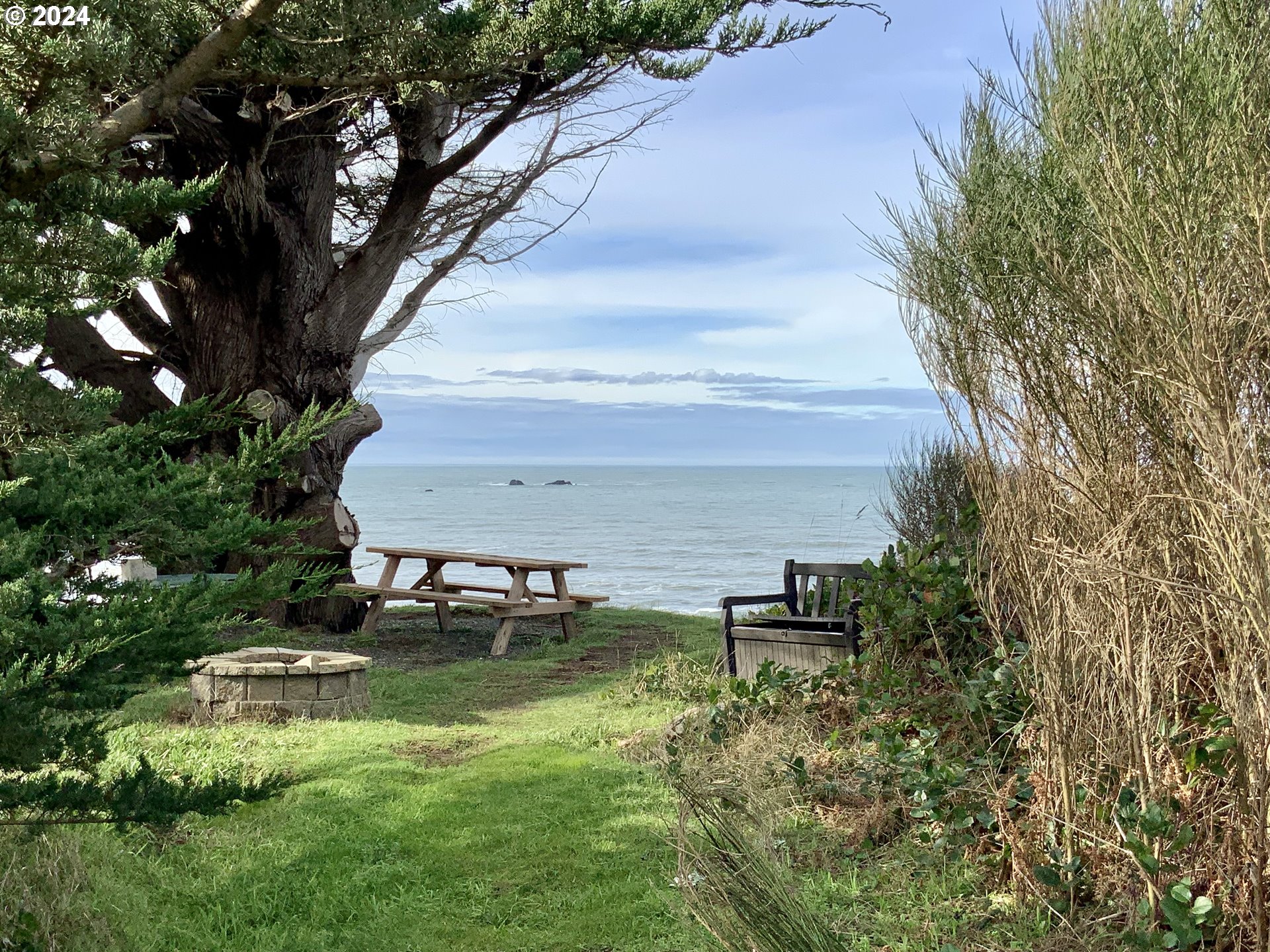 0 Surfside Drive, Unit 1101 Gold Beach, OR 97444 - Photo 15 of 19 a backyard of a house with table and chairs