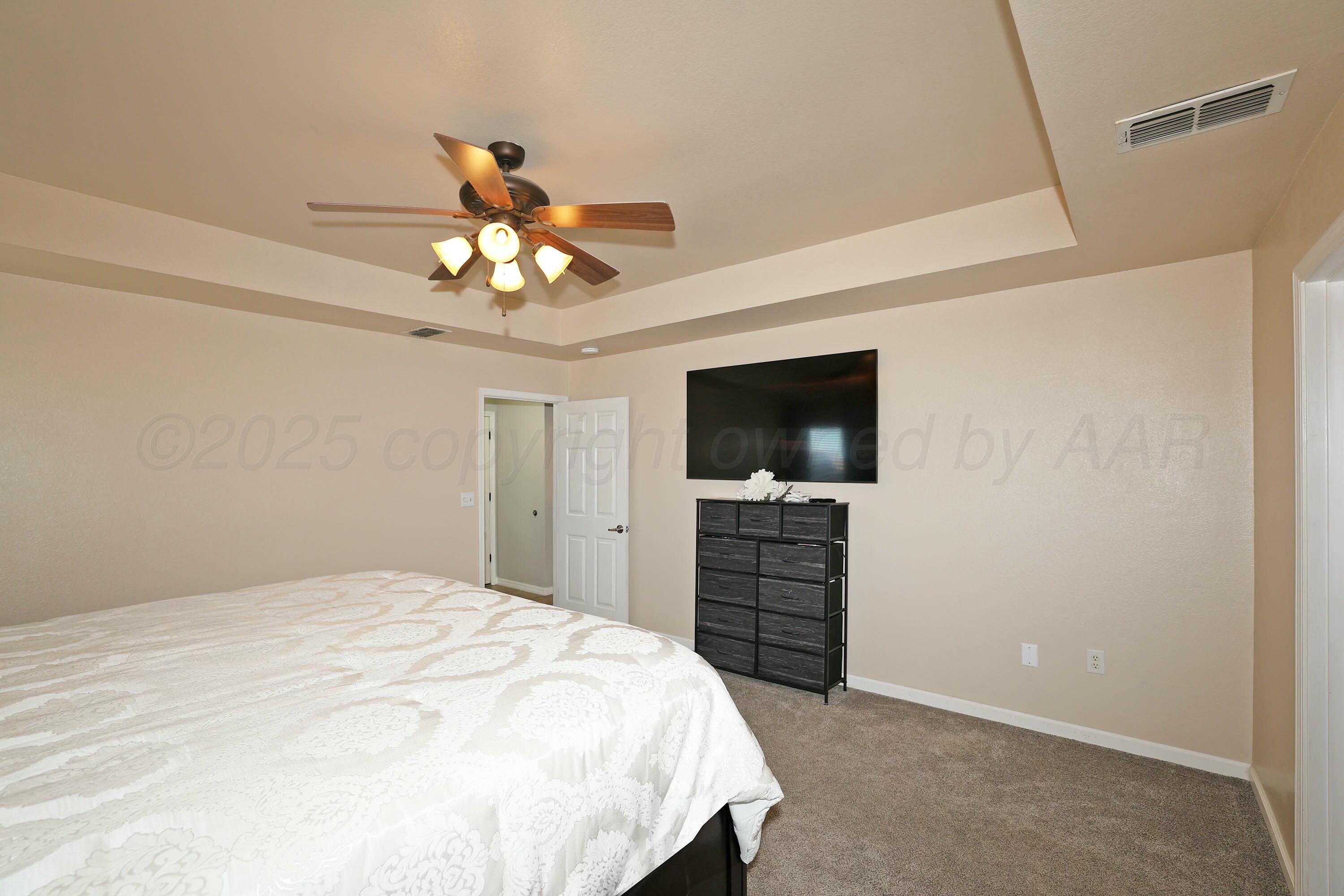 800 West McAfee Road Amarillo, TX 79118 - Photo 14 of 39 a bedroom with a bed and a flat screen tv