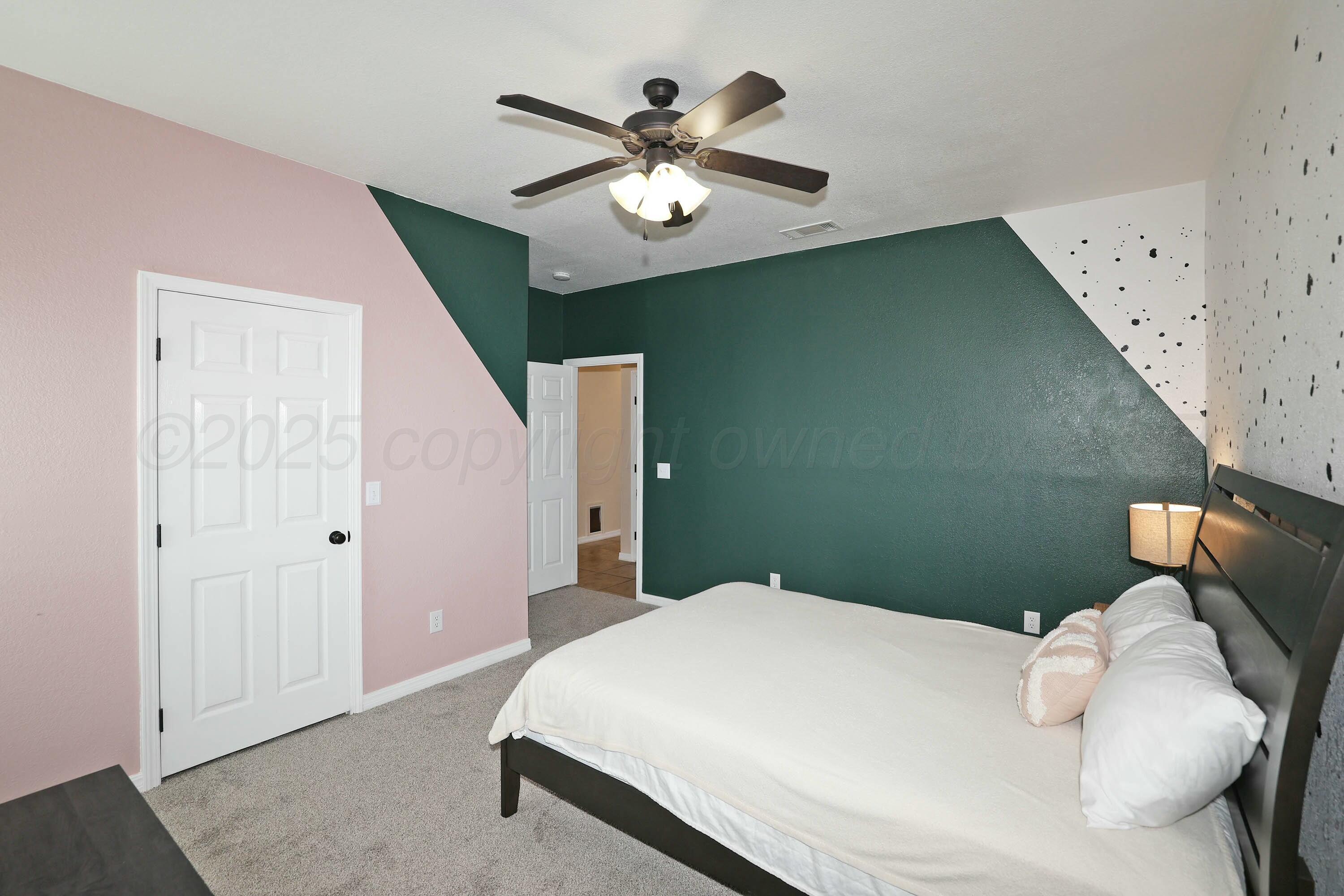 800 West McAfee Road Amarillo, TX 79118 - Photo 25 of 39 a bedroom with a bed and a chandelier