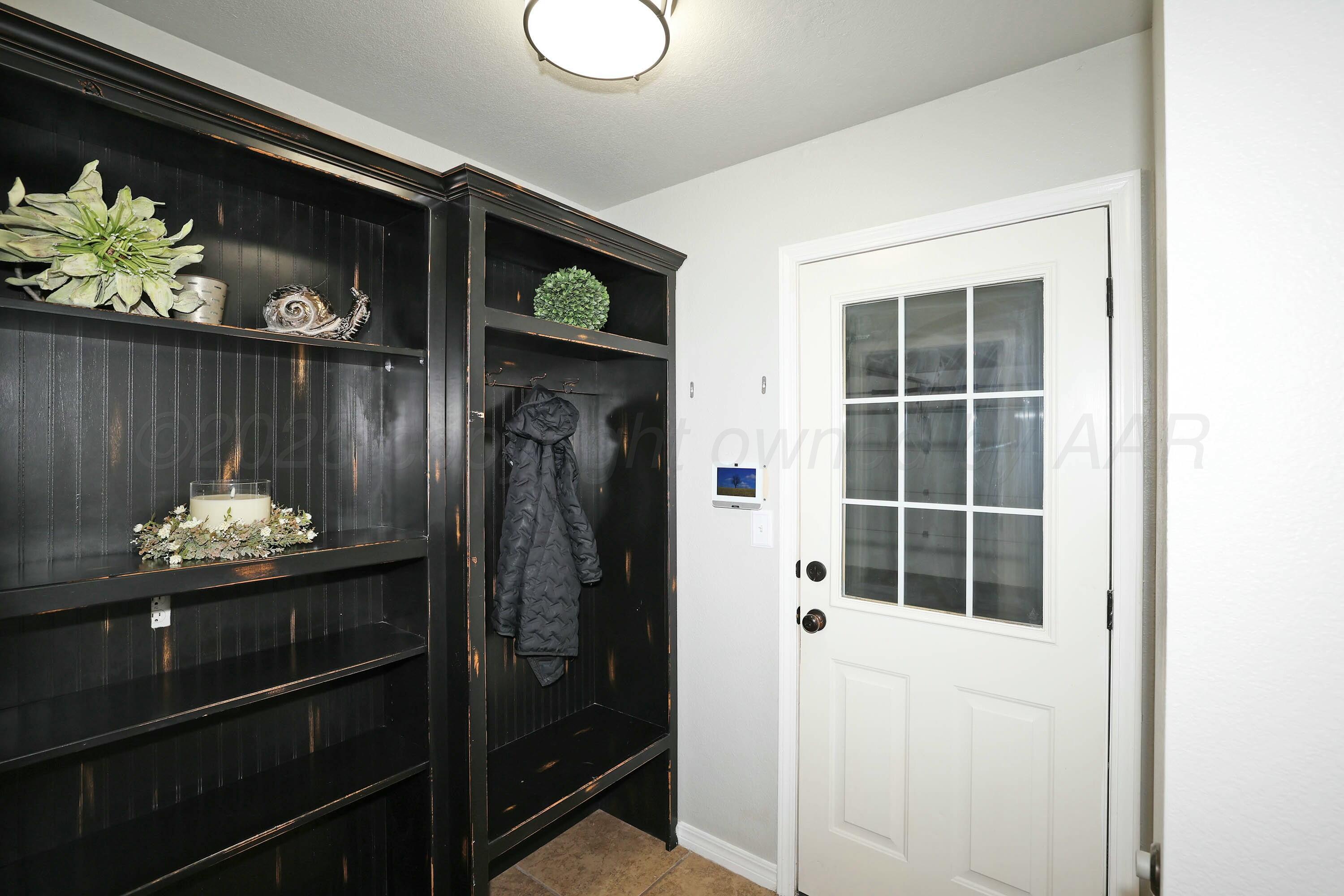 800 West McAfee Road Amarillo, TX 79118 - Photo 32 of 39 a room with a door and a wooden floor
