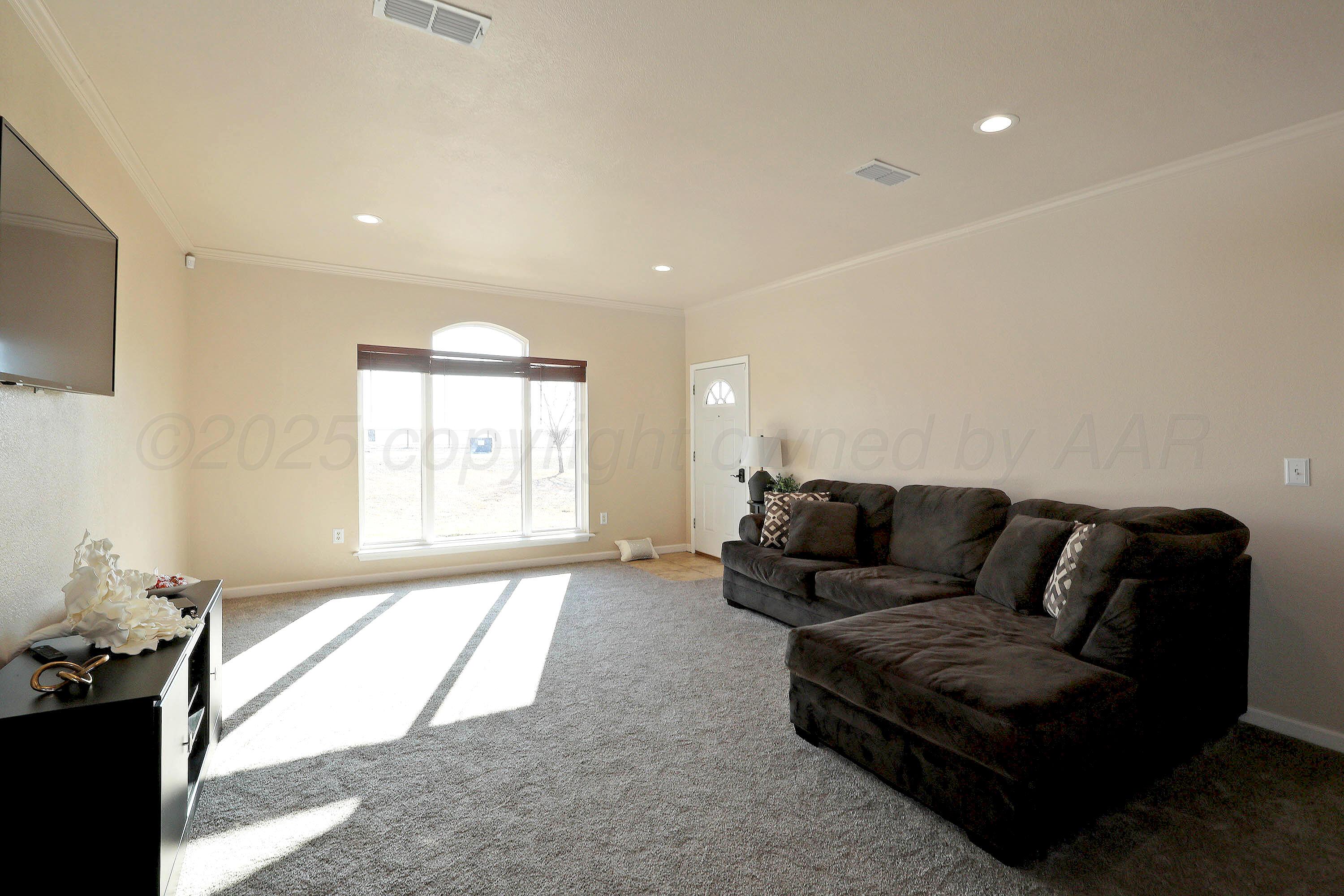 800 West McAfee Road Amarillo, TX 79118 - Photo 5 of 39 a living room with furniture window and a flat screen tv