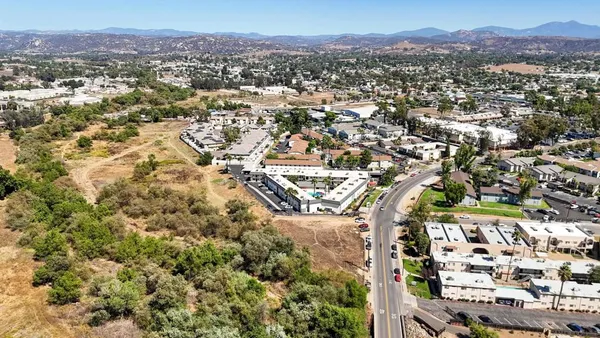 an aerial view of residential house with an outdoor space and seating