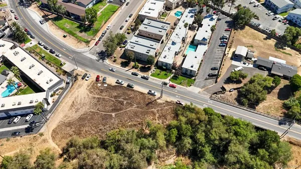 an aerial view of a residential houses with yard