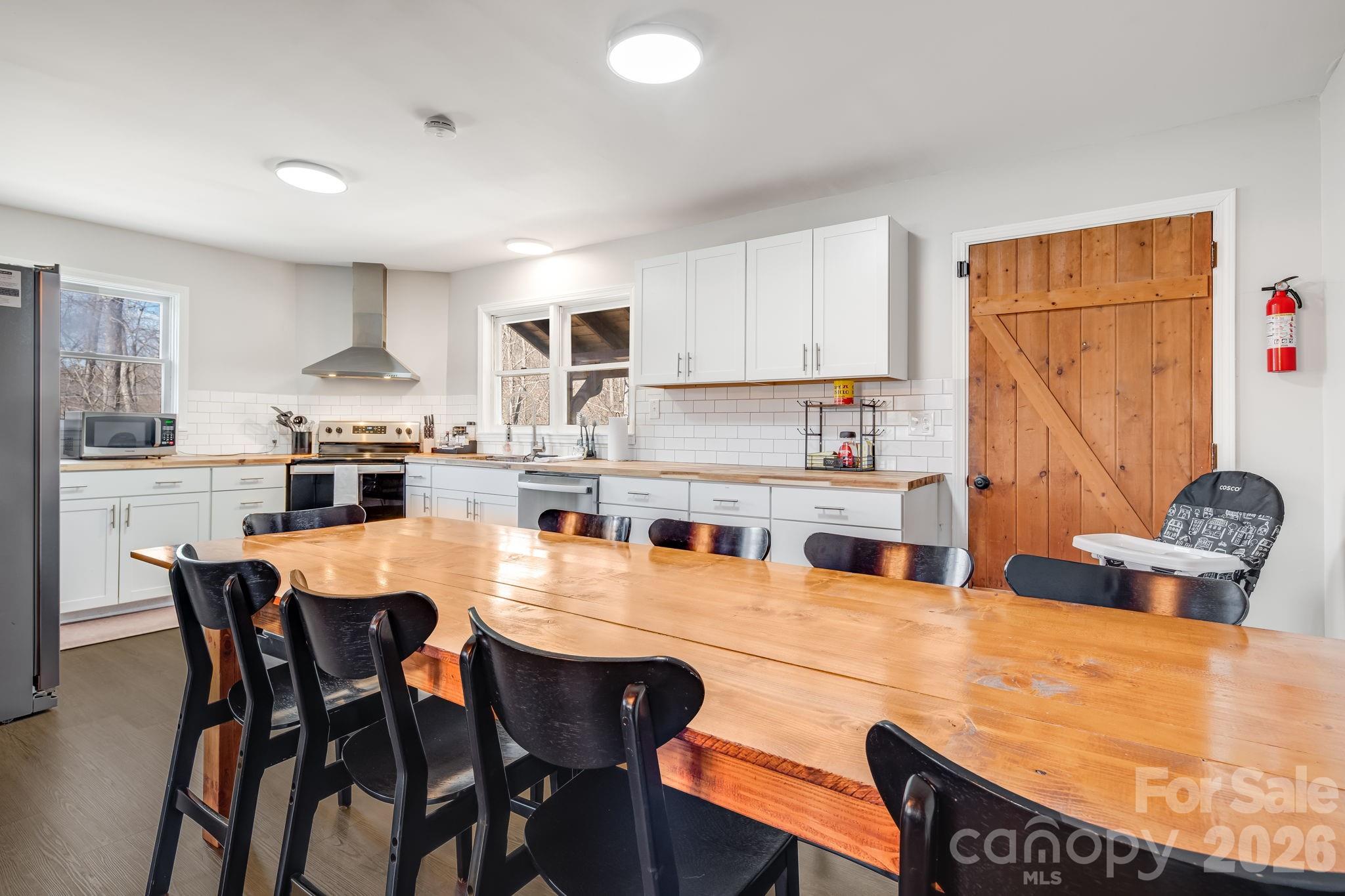 114 Johns Creek Road Canton, NC 28716 - Photo 11 of 48 a large kitchen with a table and chairs in it