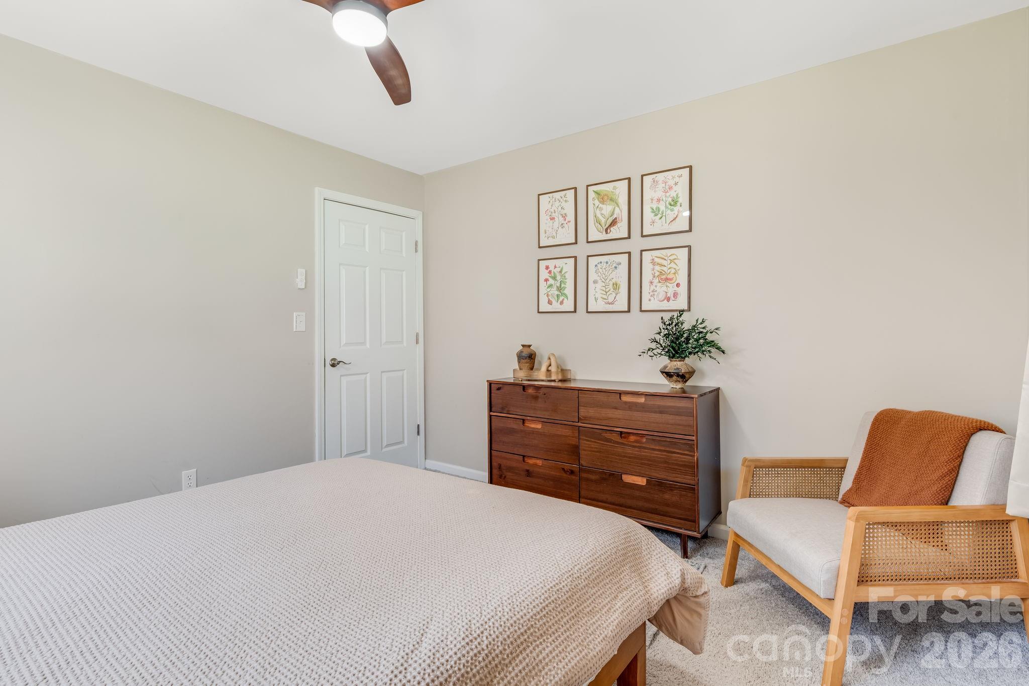 114 Johns Creek Road Canton, NC 28716 - Photo 19 of 48 a bedroom with a bed and chair