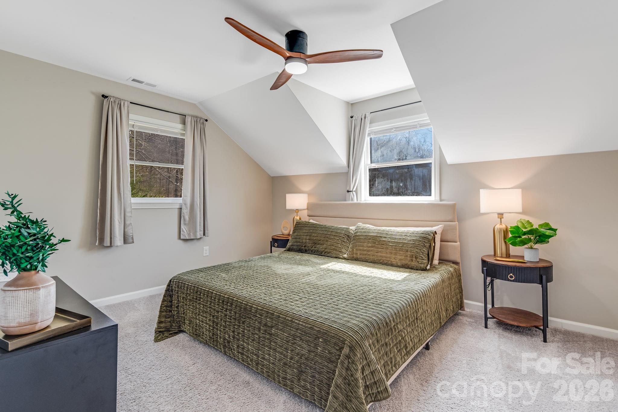 114 Johns Creek Road Canton, NC 28716 - Photo 22 of 48 a bedroom with a bed a chandelier and a window
