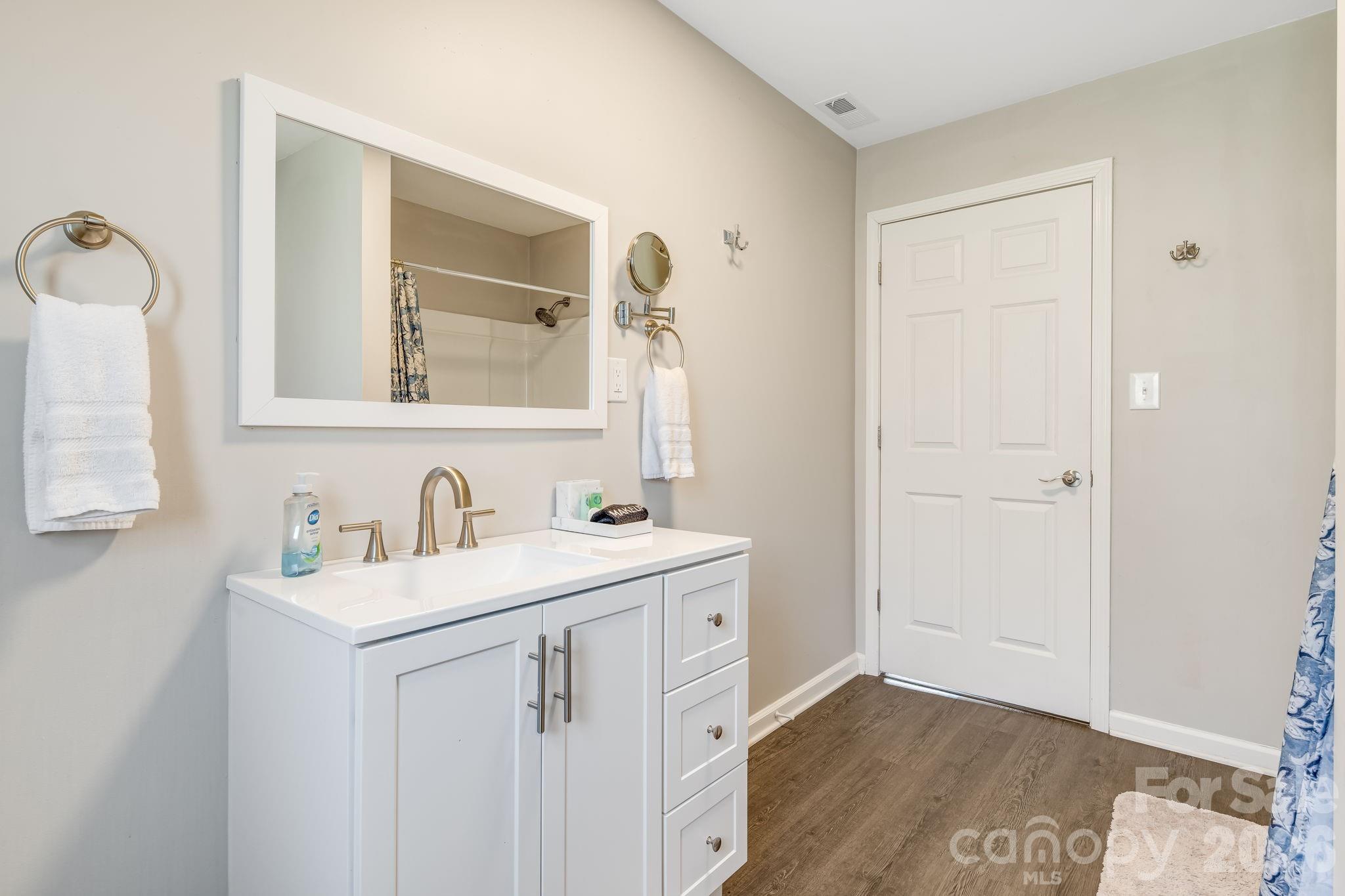 114 Johns Creek Road Canton, NC 28716 - Photo 25 of 48 a bathroom with a sink a vanity and a mirror