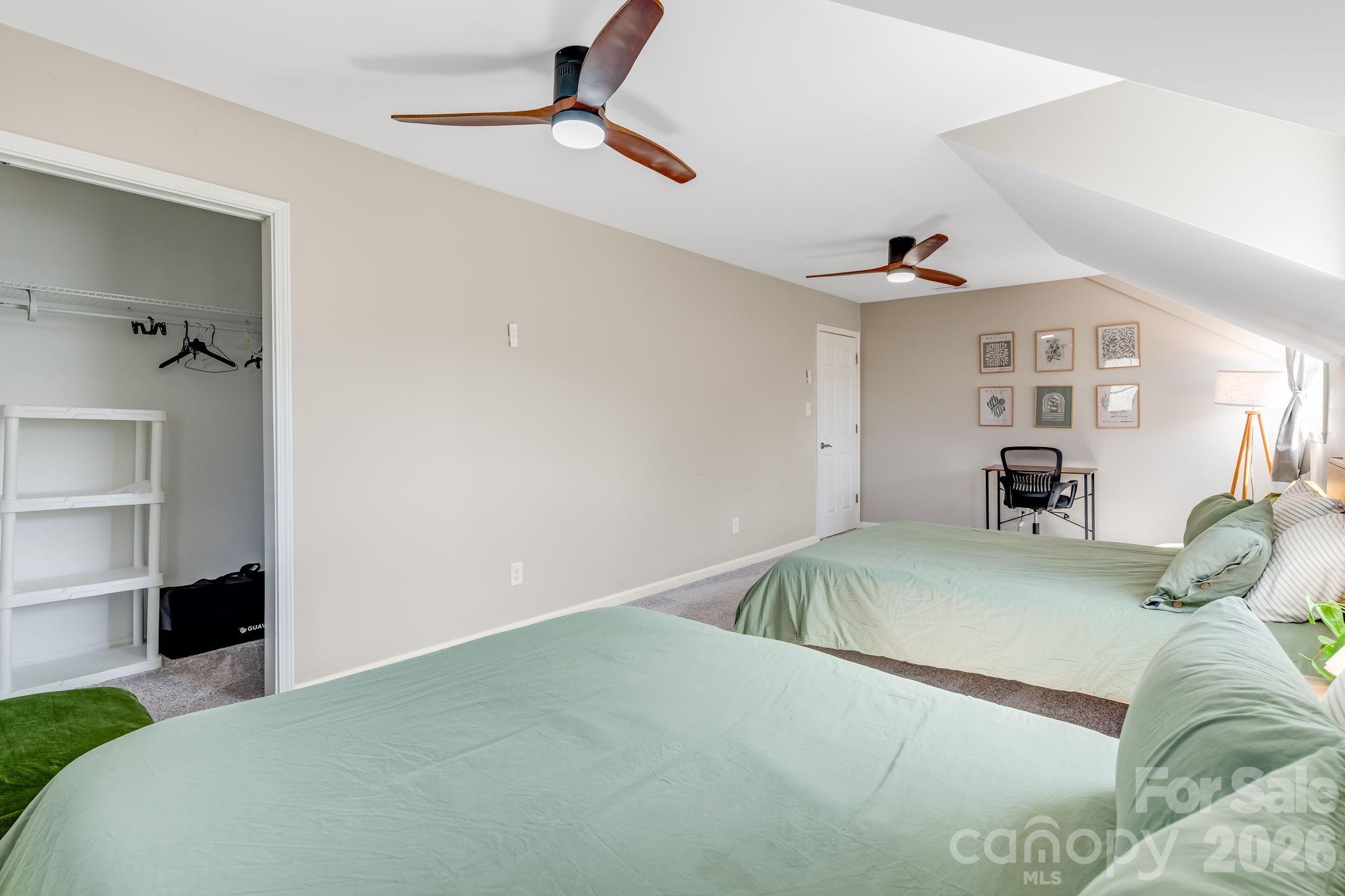 114 Johns Creek Road Canton, NC 28716 - Photo 27 of 48 a bedroom with a bed and ceiling fan