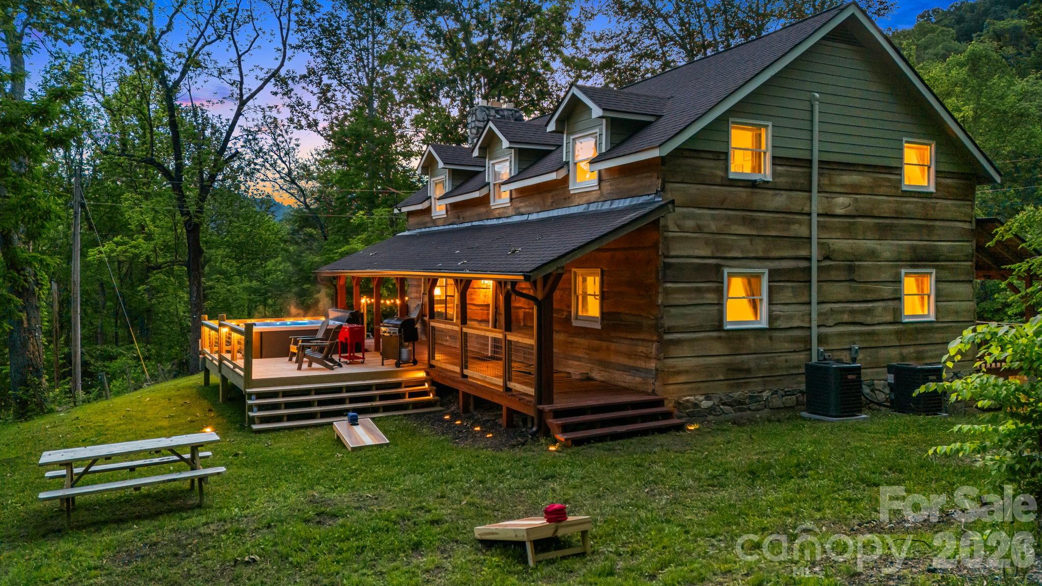 114 Johns Creek Road Canton, NC 28716 - Photo 3 of 48 a backyard of a house with barbeque oven a garden and deck