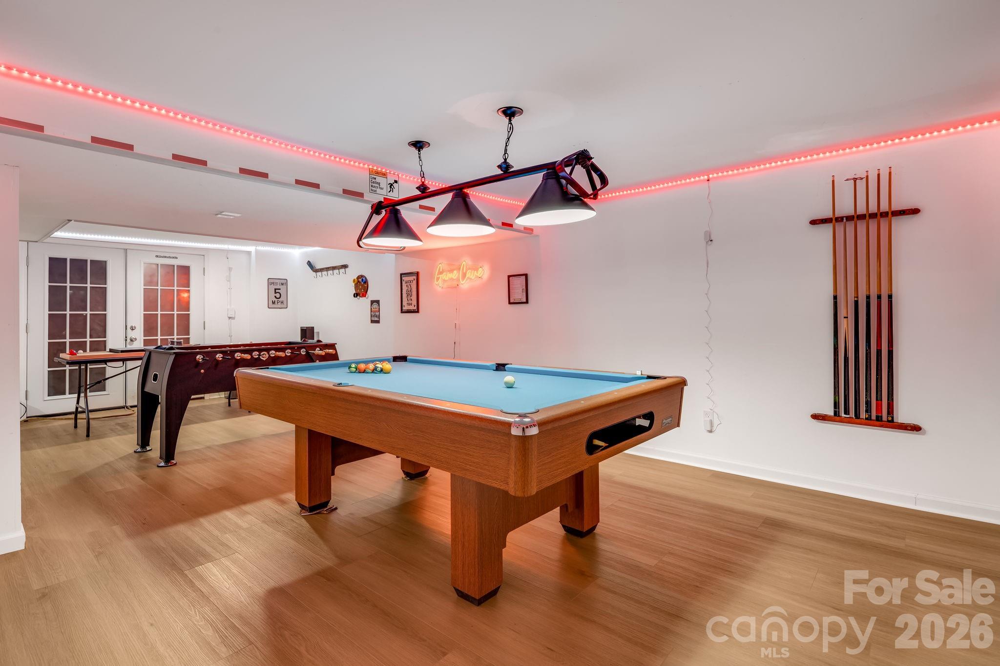 114 Johns Creek Road Canton, NC 28716 - Photo 31 of 48 a room with wooden floors pool table and windows