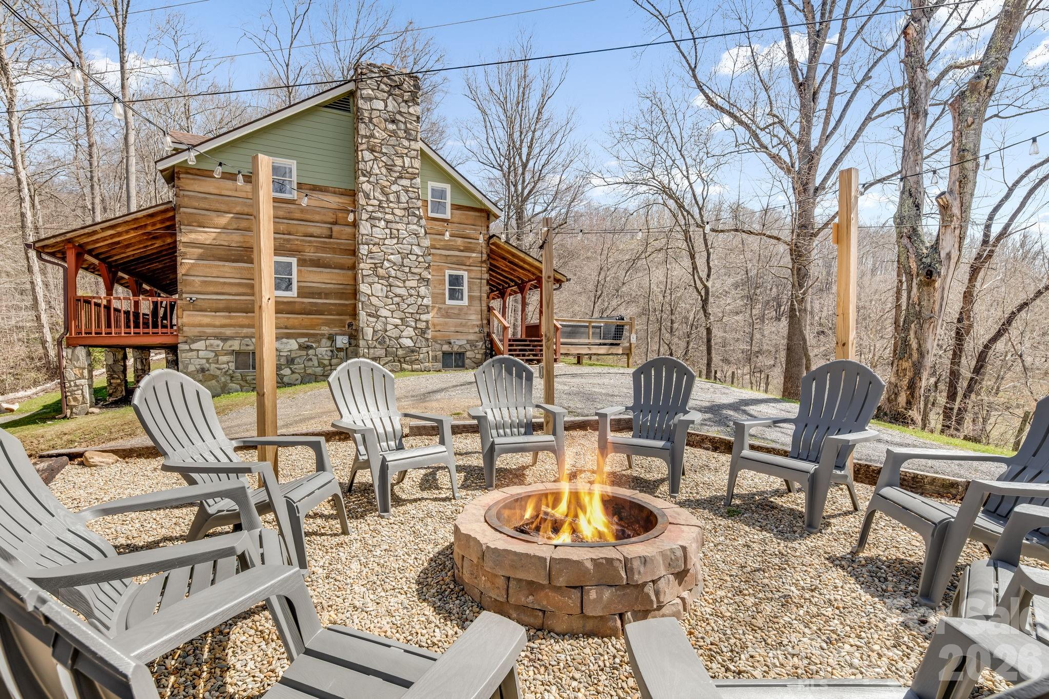 114 Johns Creek Road Canton, NC 28716 - Photo 40 of 48 a view of a patio with couches table and chairs and potted plants
