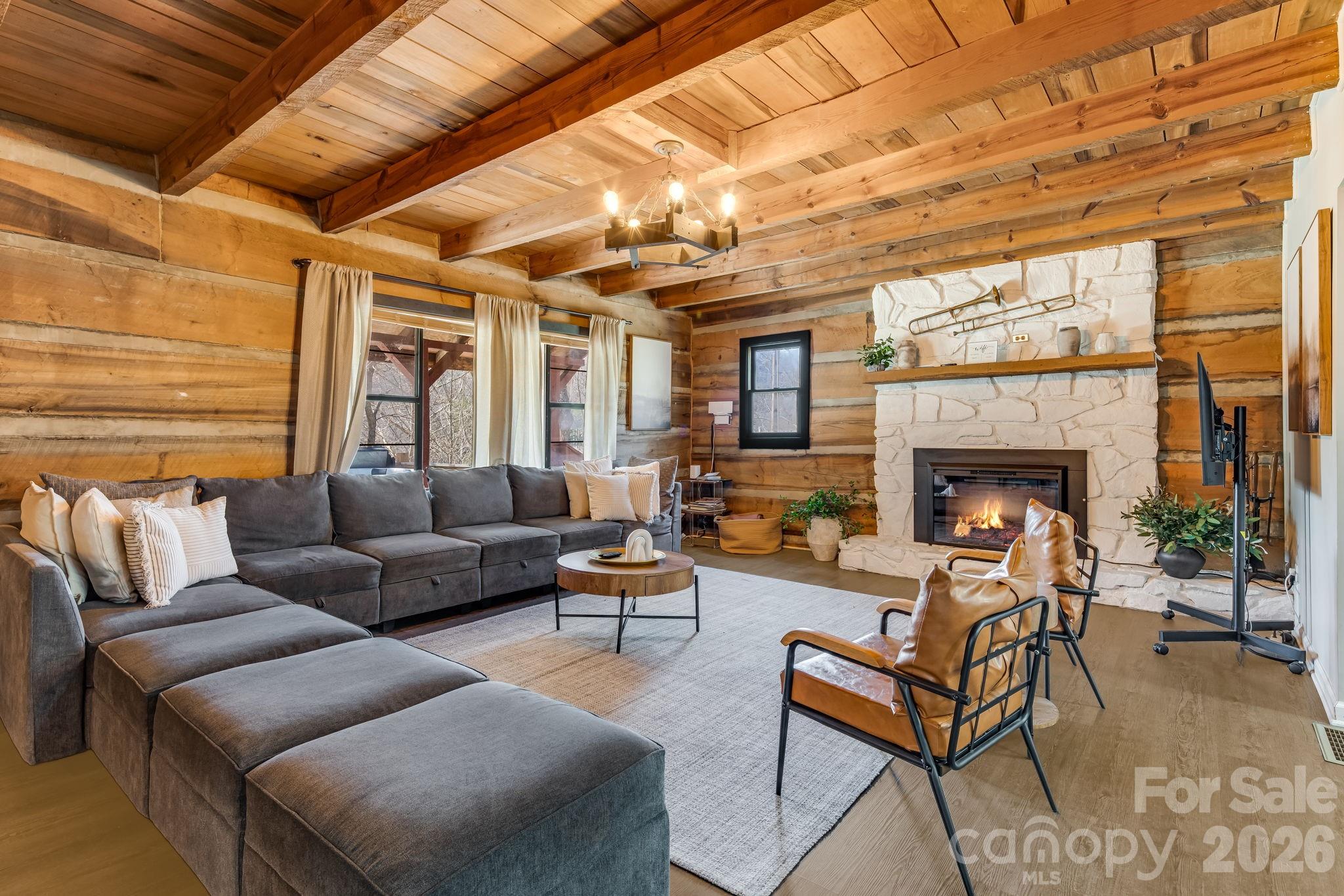 114 Johns Creek Road Canton, NC 28716 - Photo 8 of 48 a living room with furniture a fireplace and a table