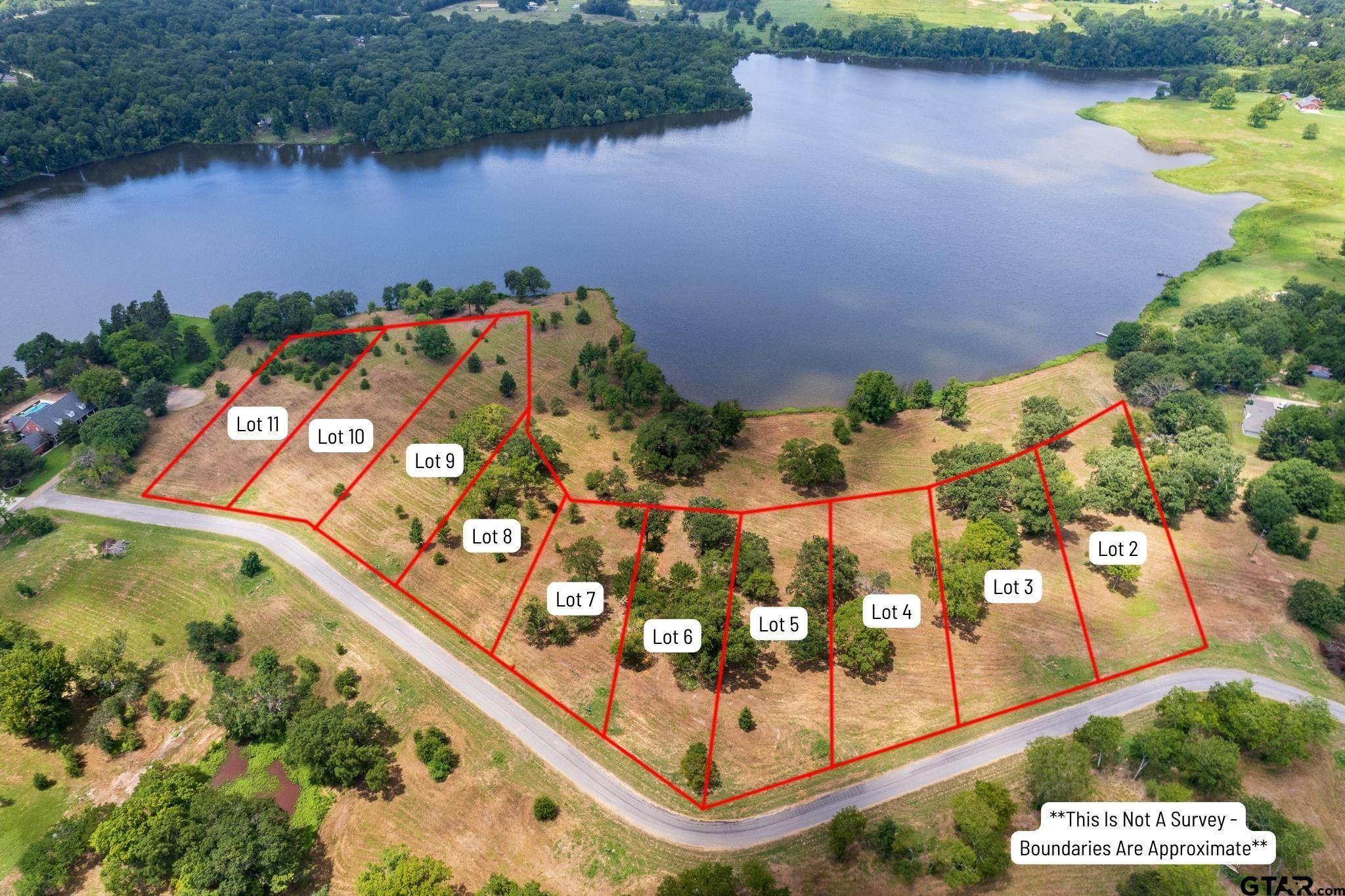 Tbd Lot 7 Tbd Way Mount Pleasant, TX 75455 - Photo 5 of 13 an aerial view of a house a yard and a pond