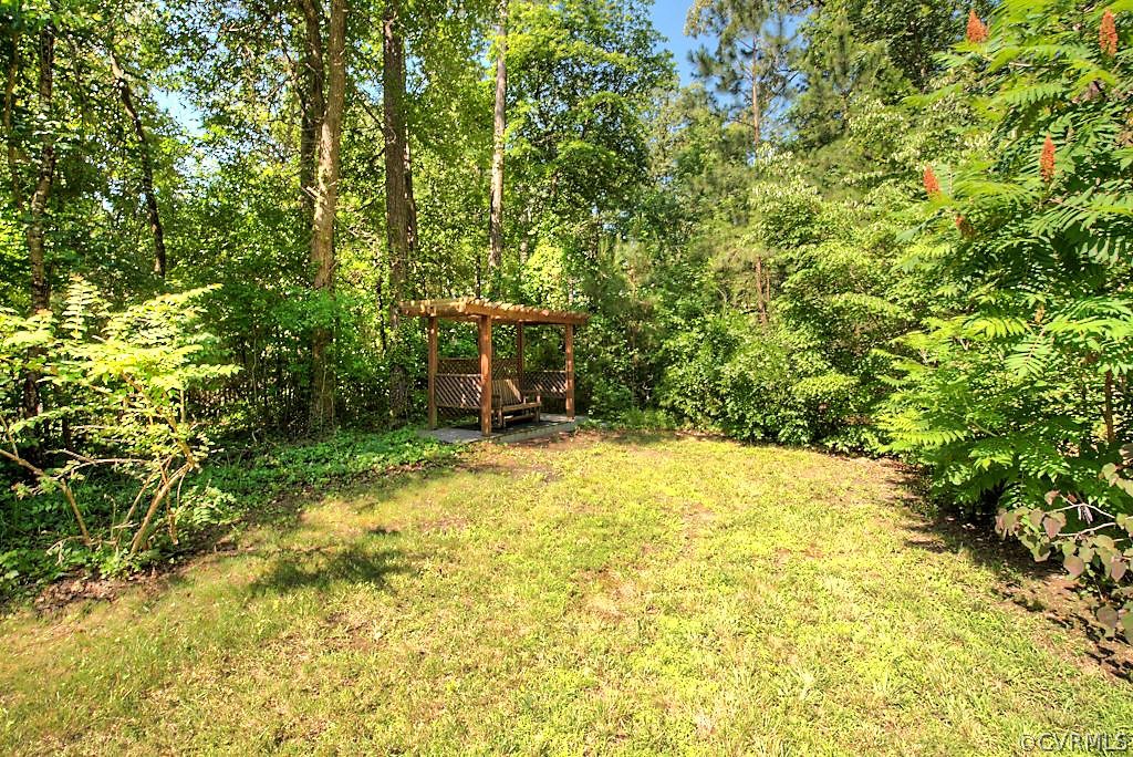 7720 Varann Road Henrico, VA 23231 - Photo 12 of 39 a backyard of a house with yard and outdoor seating