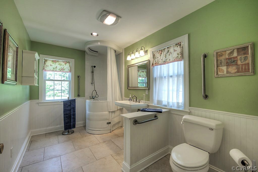 7720 Varann Road Henrico, VA 23231 - Photo 28 of 39 a spacious bathroom with a granite countertop toilet a sink and a bathtub