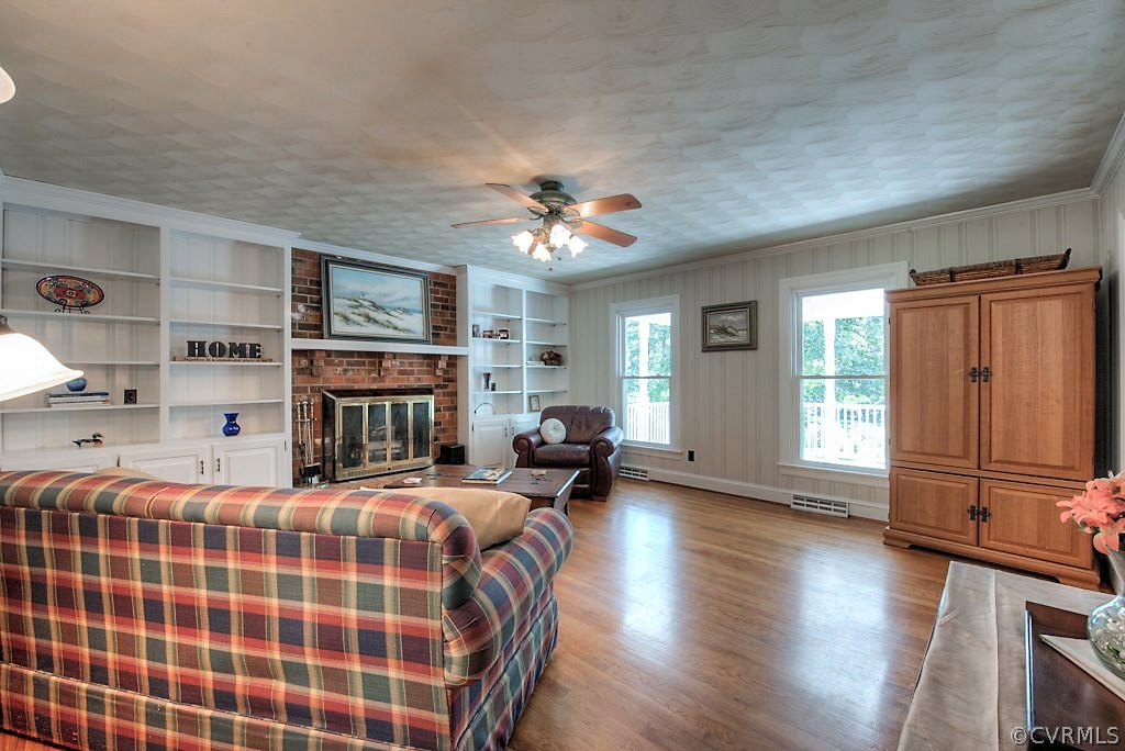 7720 Varann Road Henrico, VA 23231 - Photo 29 of 39 a bedroom with a bed a dresser and wooden floor