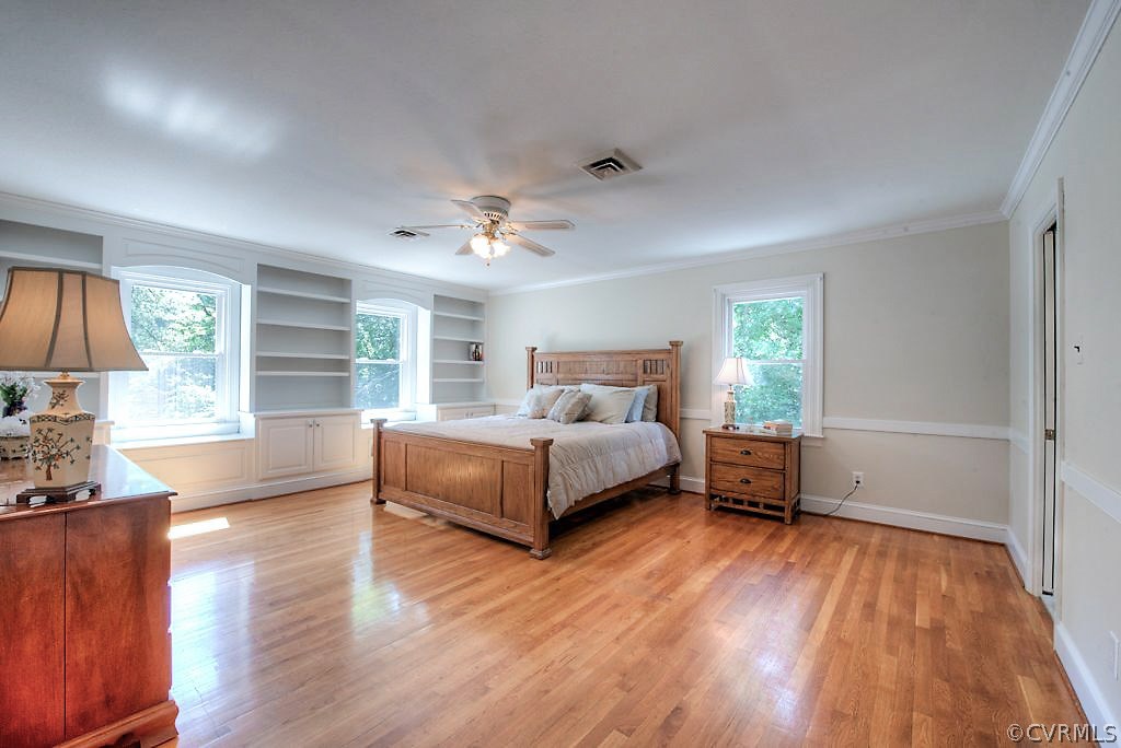 7720 Varann Road Henrico, VA 23231 - Photo 36 of 39 a spacious bedroom with a bed and wooden floor