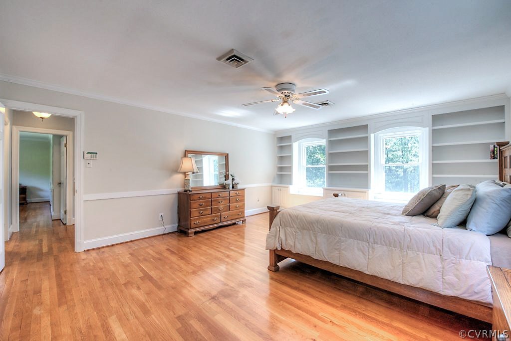 7720 Varann Road Henrico, VA 23231 - Photo 37 of 39 a bedroom with a large bed and a chandelier