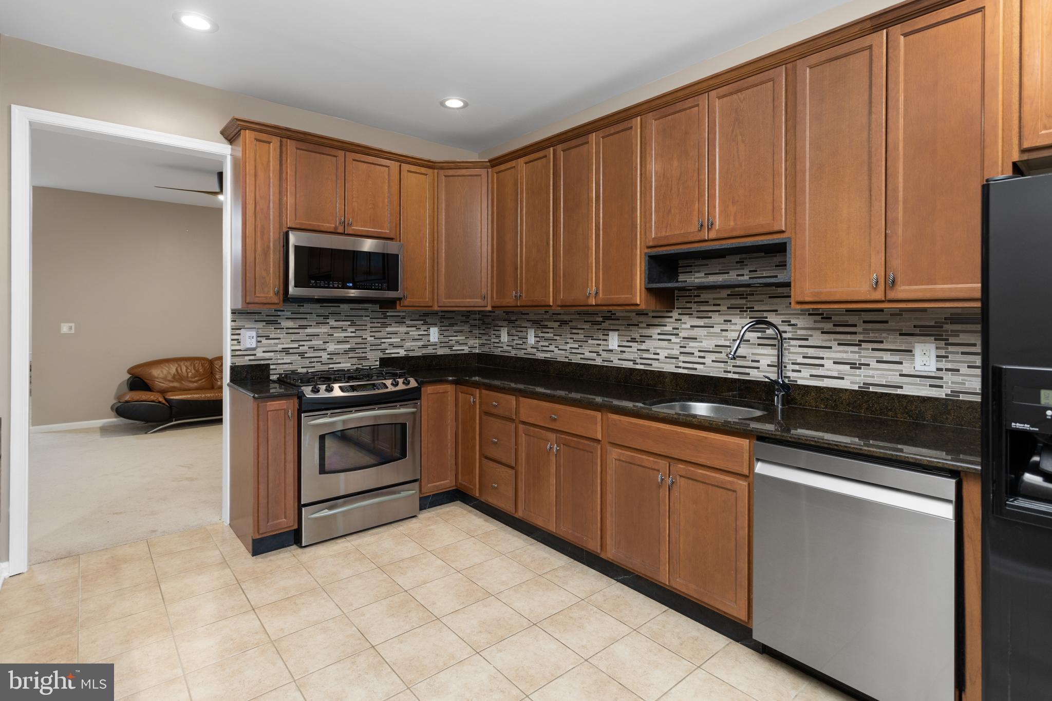 6 Flagger Lane Hamilton, NJ 08619 - Photo 13 of 32 a kitchen with stainless steel appliances granite countertop a stove a sink and a microwave