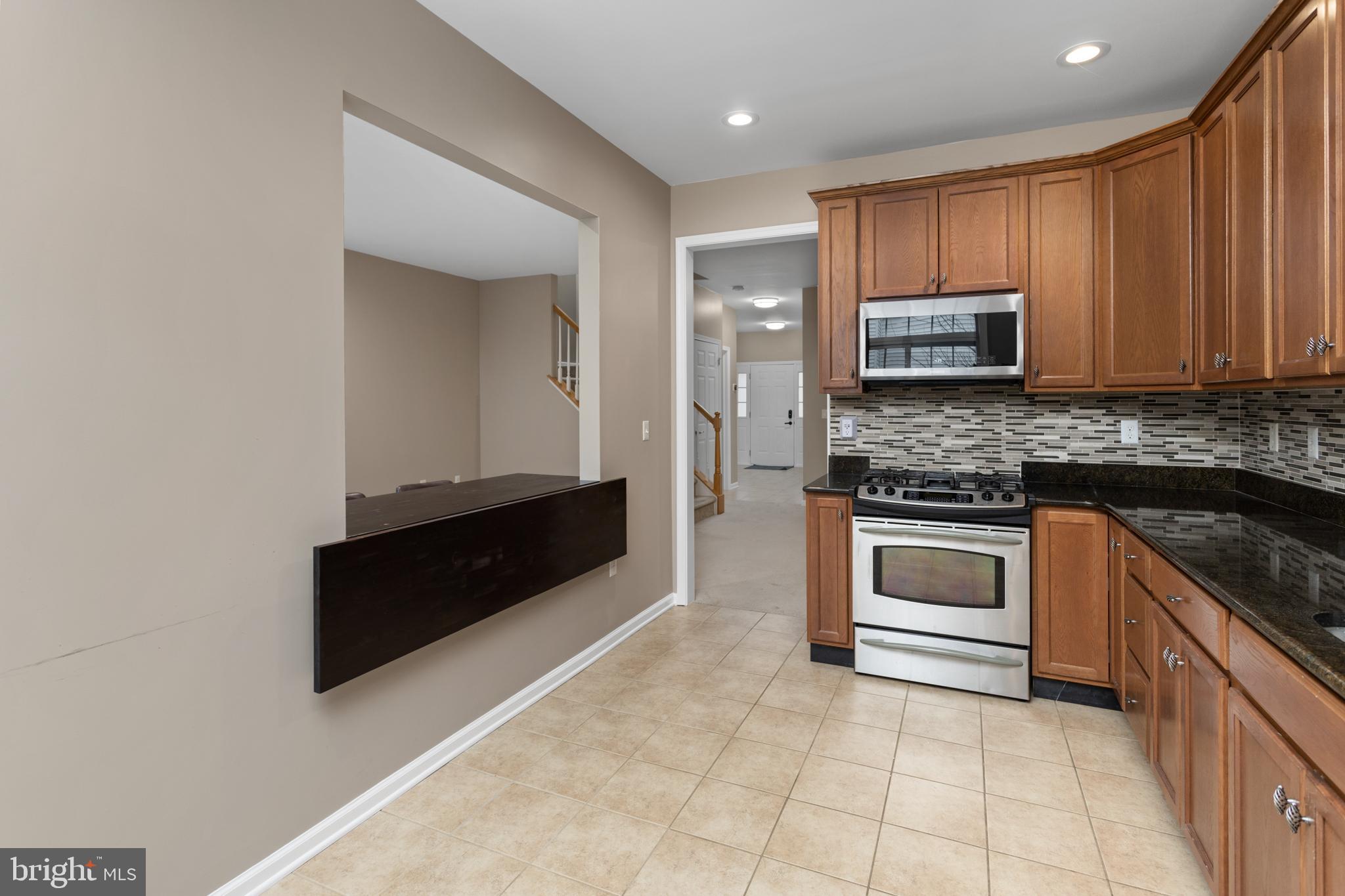 6 Flagger Lane Hamilton, NJ 08619 - Photo 15 of 32 a kitchen with granite countertop a stove and a microwave