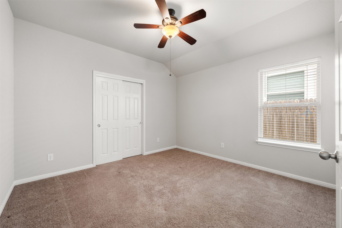 433 Rusk Bluff Avenue Leander, TX 78641 - Photo 13 of 22 Unfurnished bedroom featuring carpet, a closet, lofted ceiling, and ceiling fan