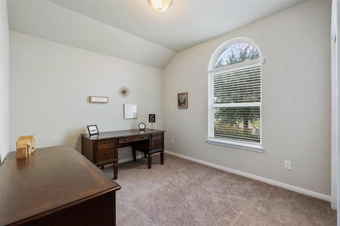 433 Rusk Bluff Avenue Leander, TX 78641 - Photo 16 of 22 Office area with light colored carpet and vaulted ceiling