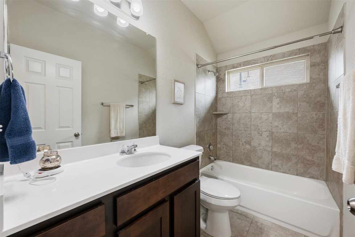 433 Rusk Bluff Avenue Leander, TX 78641 - Photo 18 of 22 Full bathroom with vaulted ceiling, shower / tub combination, vanity, and tile patterned floors