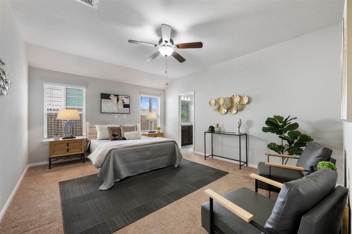 433 Rusk Bluff Avenue Leander, TX 78641 - Photo 10 of 22 Bedroom with light colored carpet, a ceiling fan, and ensuite bath