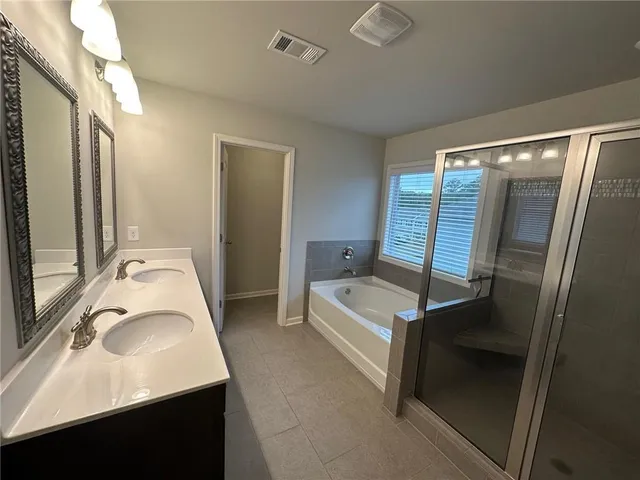 a bathroom with a bathtub and a shower