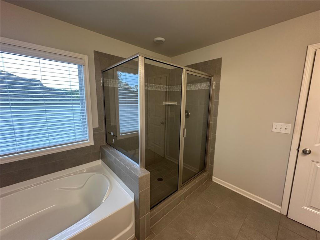 623 Little Bear Loop Canton, GA 30114 - Photo 12 of 24 a bathroom with a bathtub and a shower