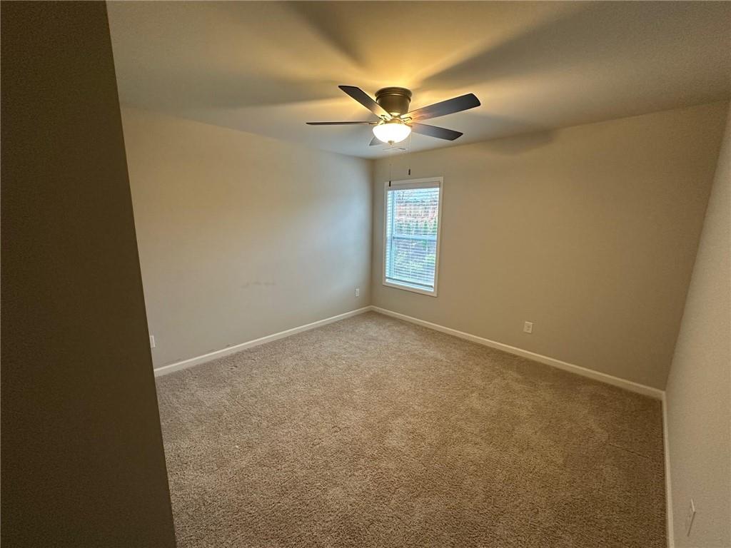 623 Little Bear Loop Canton, GA 30114 - Photo 17 of 24 an empty room with windows and fan