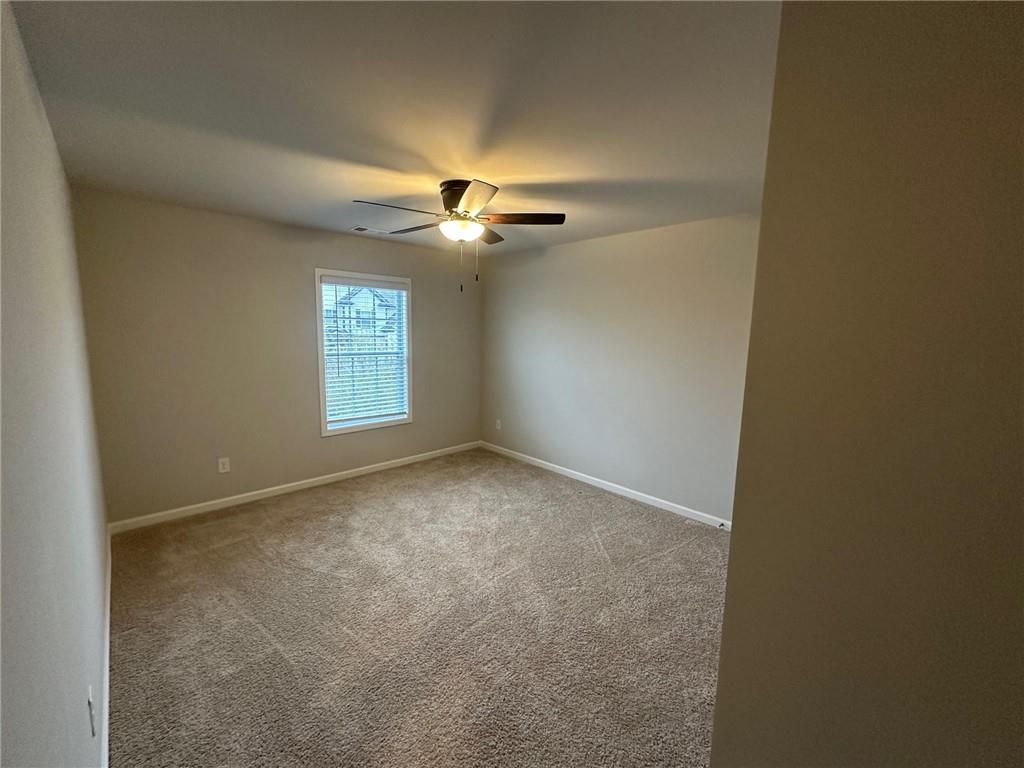 623 Little Bear Loop Canton, GA 30114 - Photo 19 of 24 an empty room with windows and ceiling fan view