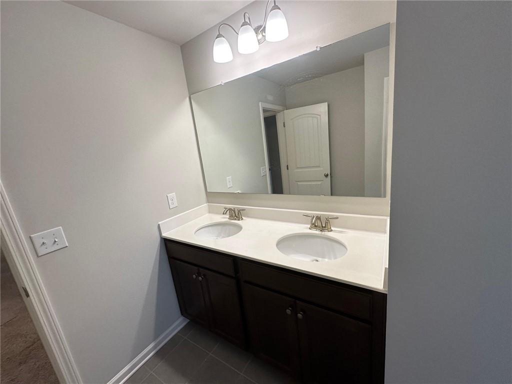 623 Little Bear Loop Canton, GA 30114 - Photo 22 of 24 a bathroom with a double vanity sink and a mirror