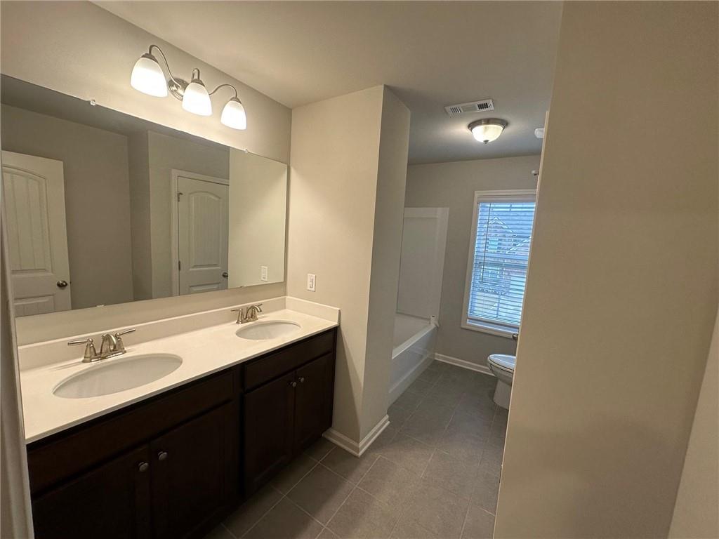623 Little Bear Loop Canton, GA 30114 - Photo 23 of 24 a bathroom with a sink vanity and mirror