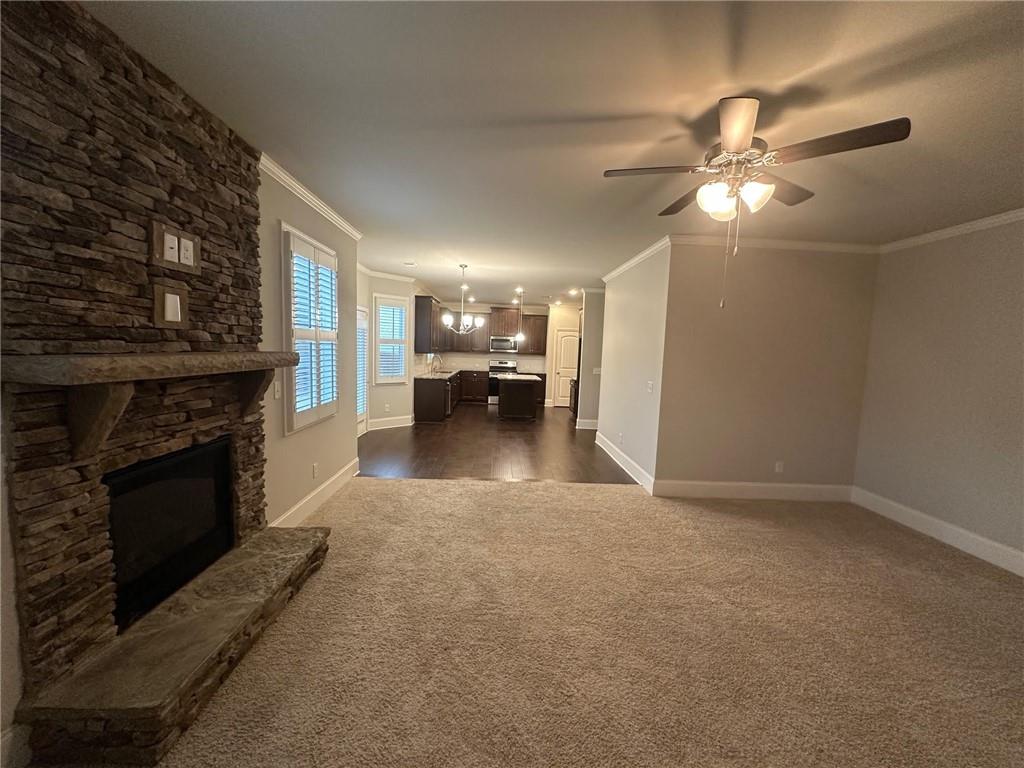 623 Little Bear Loop Canton, GA 30114 - Photo 4 of 24 a view of a livingroom with a fireplace and chandelier fan