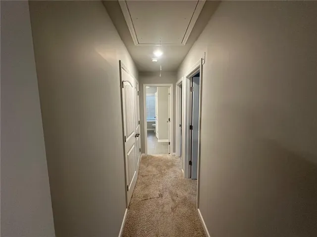 an empty room with windows and ceiling fan