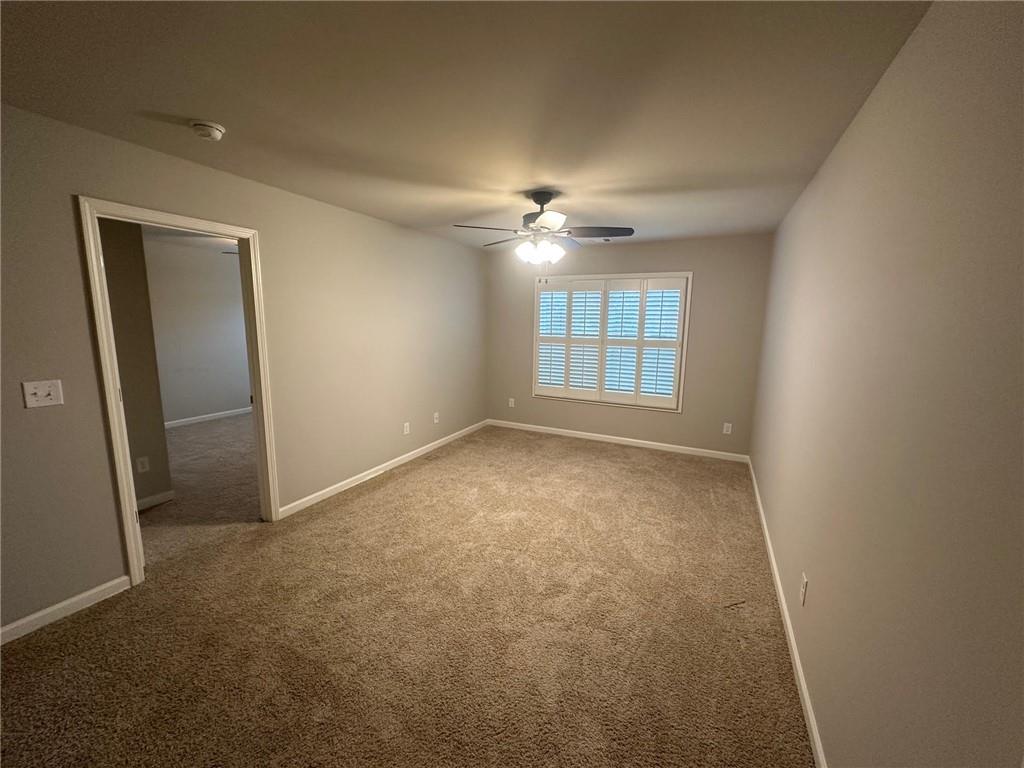 623 Little Bear Loop Canton, GA 30114 - Photo 8 of 24 an empty room with windows and ceiling fan