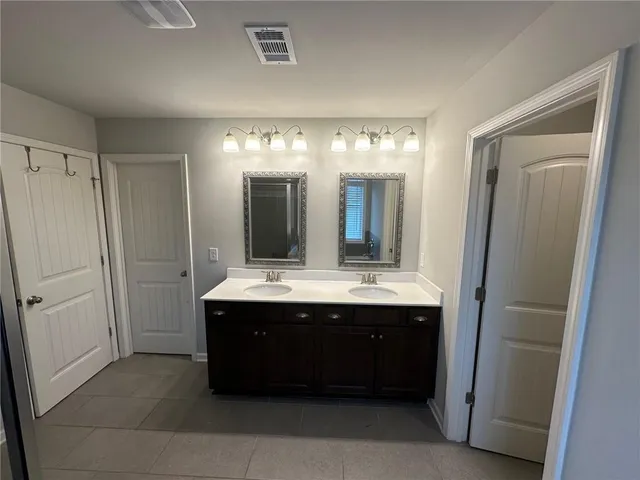 a spacious bathroom with a bathtub sink and mirror