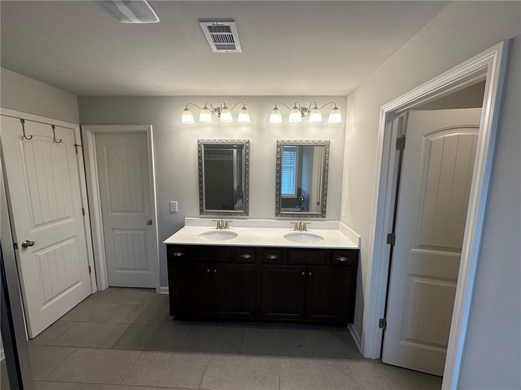 623 Little Bear Loop Canton, GA 30114 - Photo 9 of 24 a view with a sink and mirror