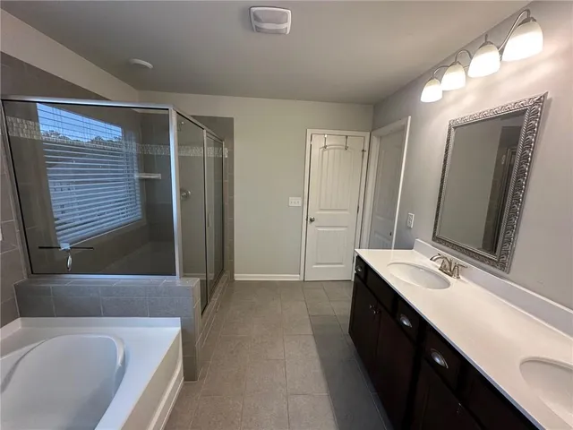 a bathroom with a sink a bathtub and a mirror
