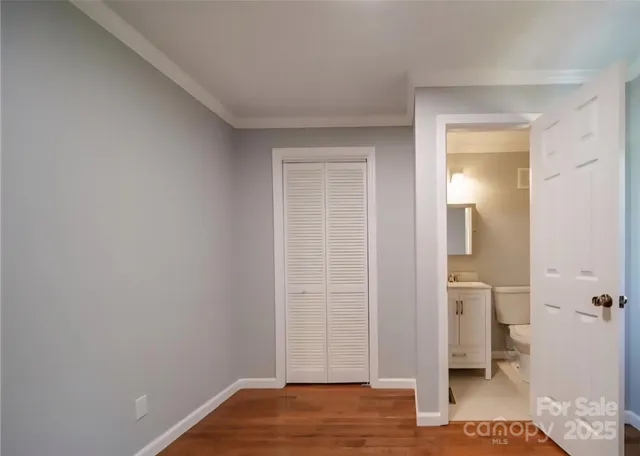 a view of a lush green forest with trees and some houses