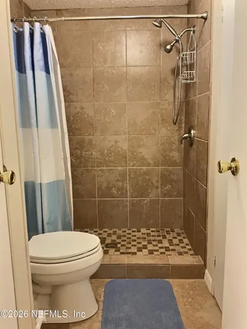 a bathroom with a toilet and shower